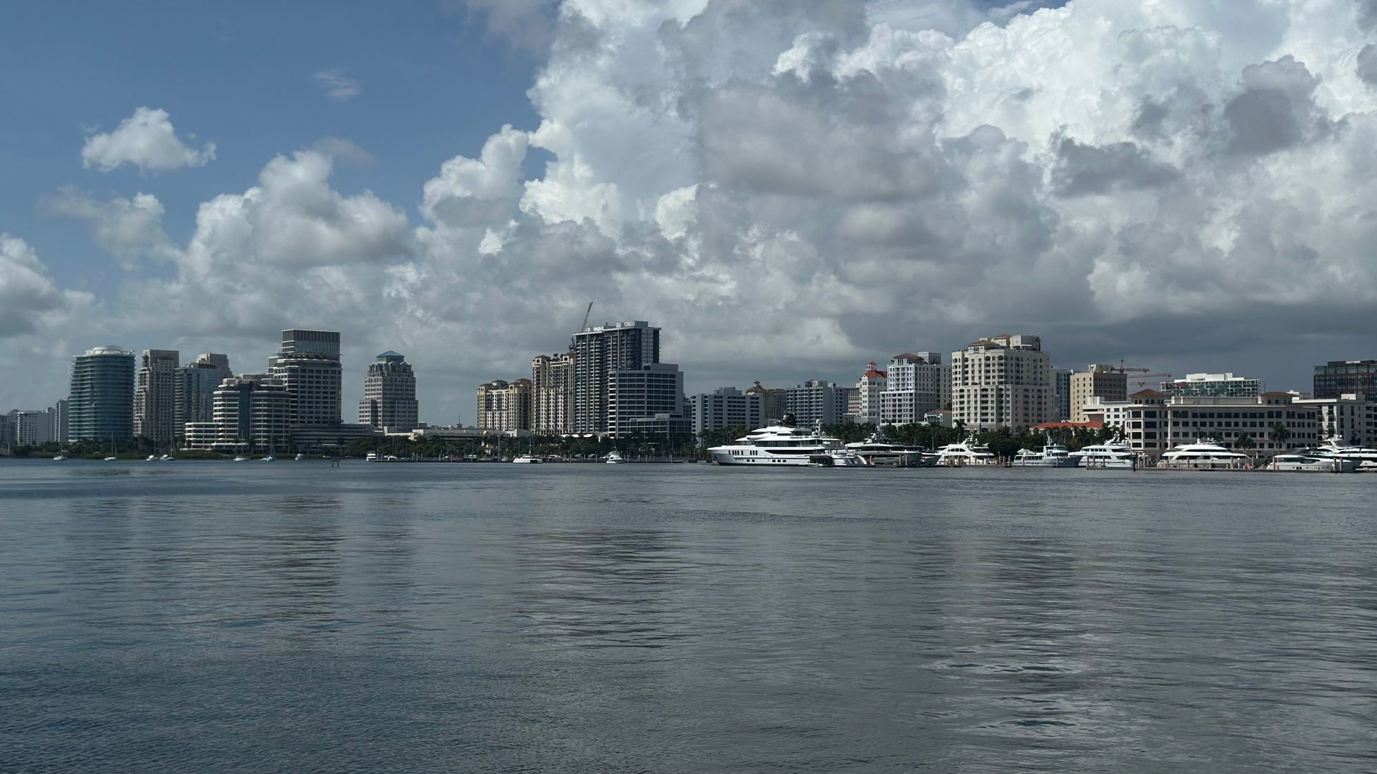 The West Palm Beach skyline across the Intracoastal Waterway under summer clouds